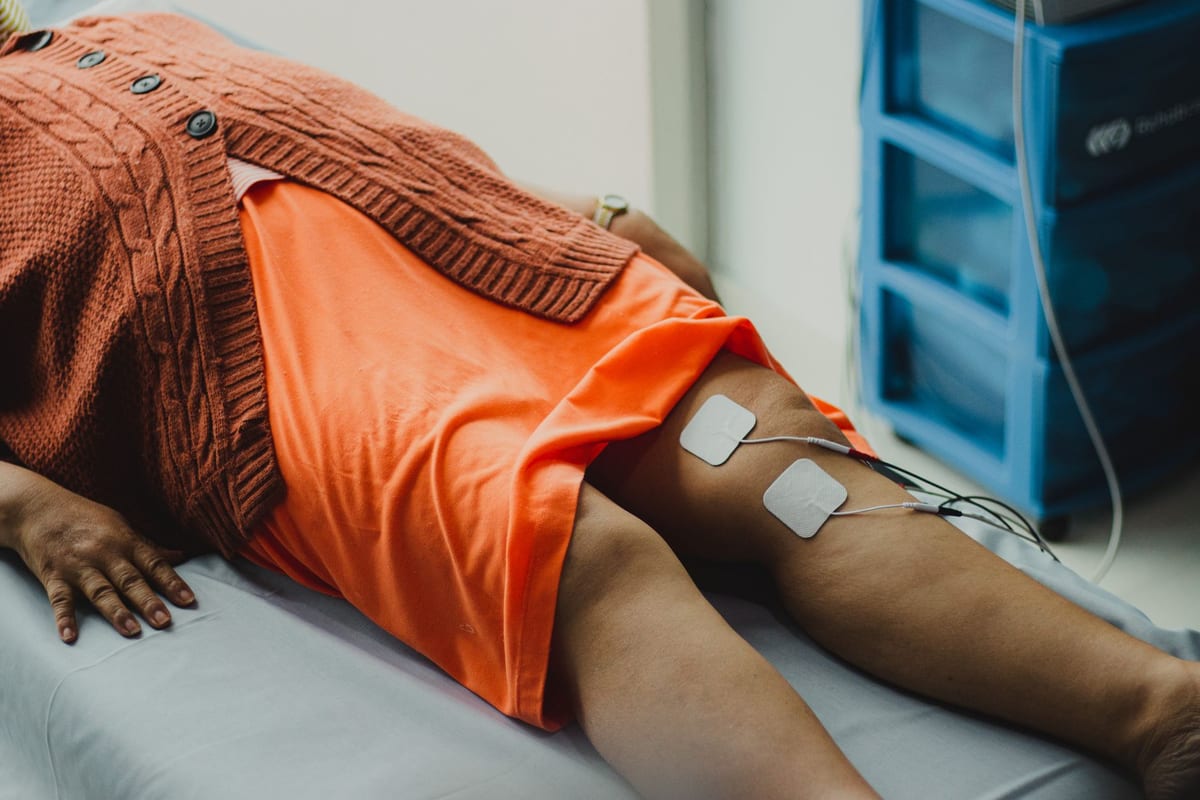 Therapy electrodes placed on a patient's leg on a treatment table